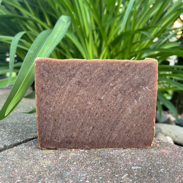 brown freshly cut soap bar on a ledge outside