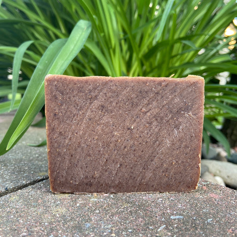 brown freshly cut soap bar on a ledge outside